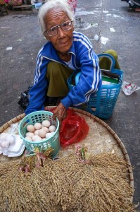 Street seller in a Yangon market with eggs