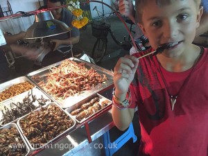 Eating deep fried scorpions in Bangkok, Thailand