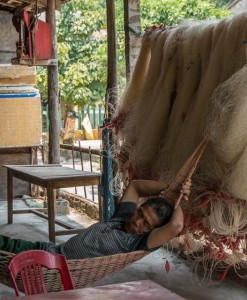 Man sleeping by his fishing nets